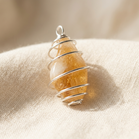 Brown and gold crystal pendant on ivory linen