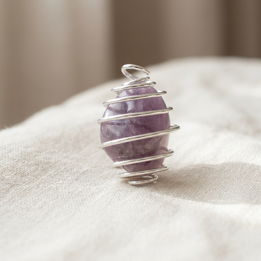 Purple crystal pendant on ivory linen